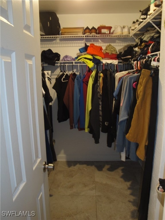 walk in closet with tile patterned floors