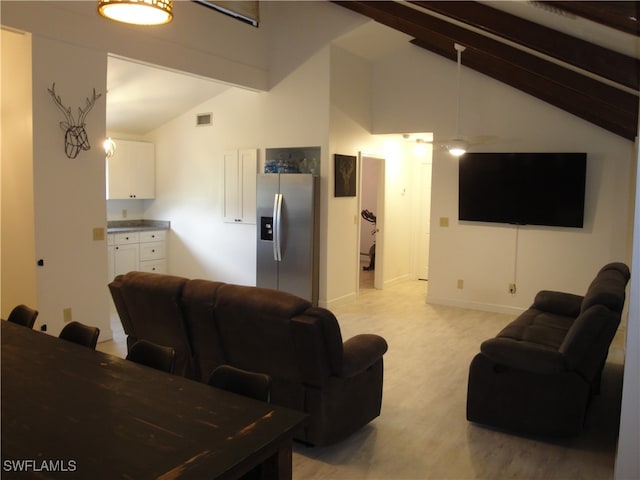 living room featuring light colored carpet and vaulted ceiling with beams