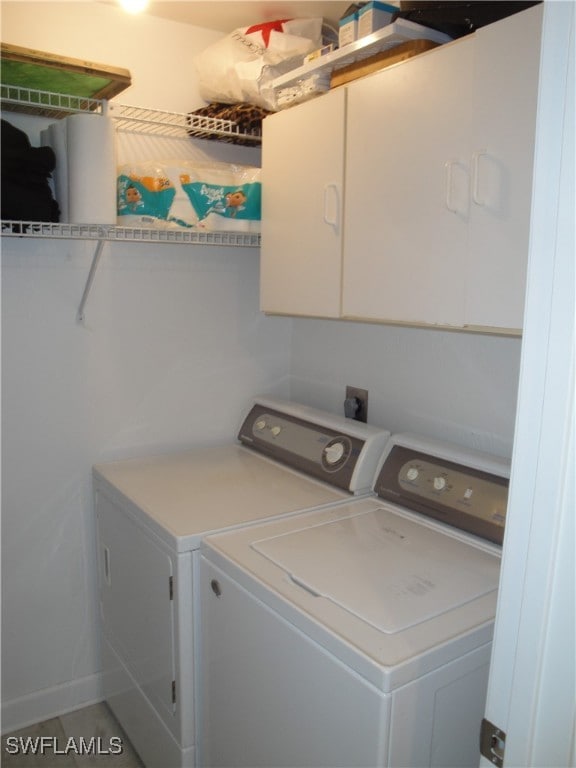 laundry area featuring cabinets and separate washer and dryer