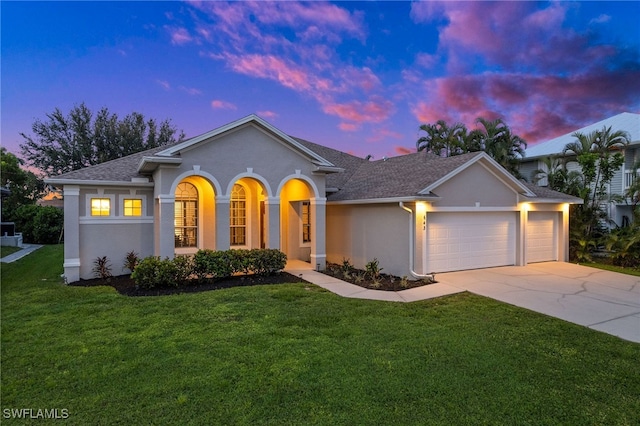 view of front of house featuring a lawn and a garage