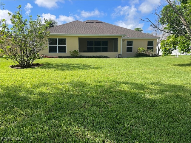 back of house with a yard