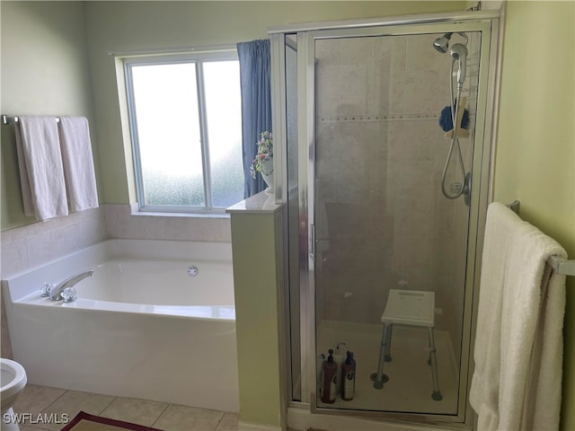 bathroom with a wealth of natural light, independent shower and bath, and tile patterned floors