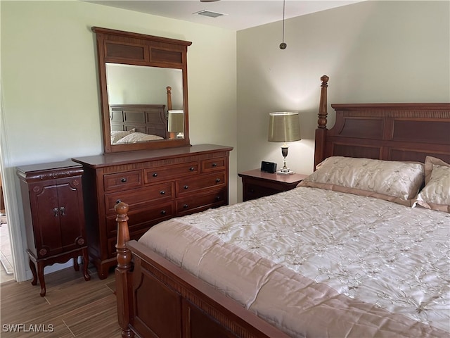 bedroom with dark hardwood / wood-style floors