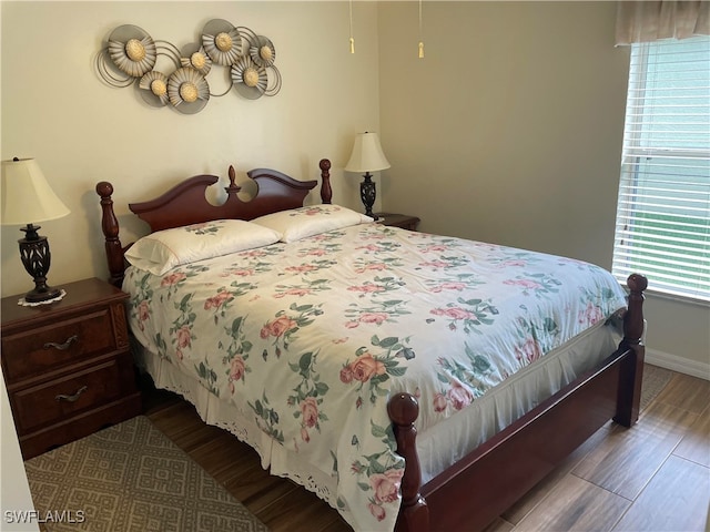 bedroom with hardwood / wood-style flooring