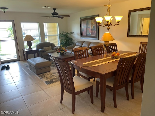 dining room with light tile patterned floors and ceiling fan with notable chandelier