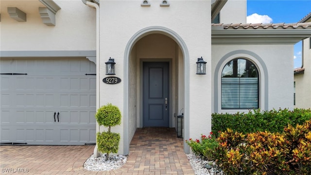 view of exterior entry featuring a garage