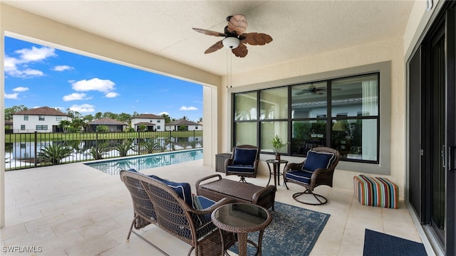 view of patio with ceiling fan and a water view