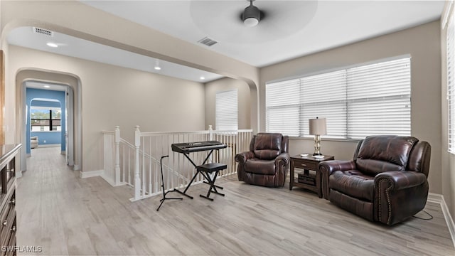 sitting room featuring ceiling fan and light hardwood / wood-style flooring