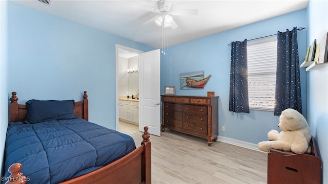 bedroom featuring light hardwood / wood-style flooring, connected bathroom, and ceiling fan