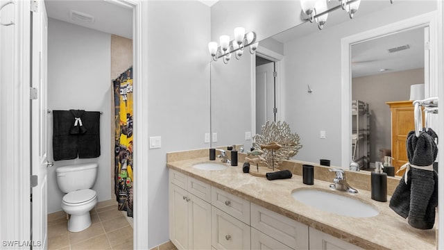 bathroom with tile patterned flooring, toilet, and vanity