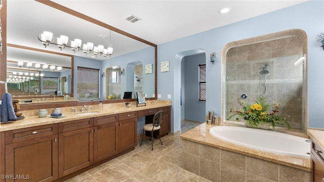 bathroom with vanity and separate shower and tub