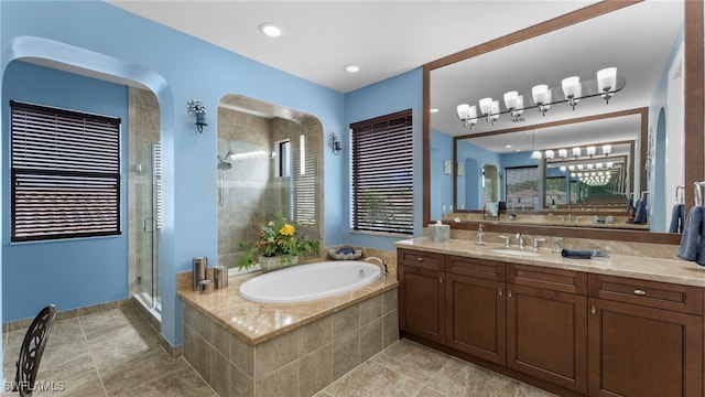 bathroom with tile patterned flooring, separate shower and tub, and vanity