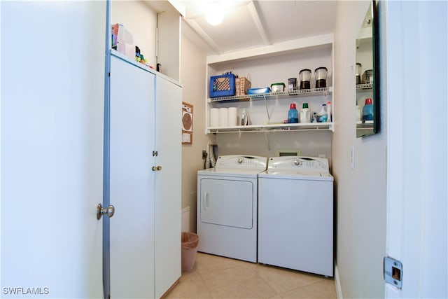 laundry room with light tile patterned floors and washing machine and clothes dryer