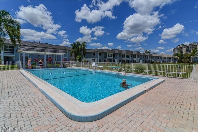 view of pool with a yard and a patio area