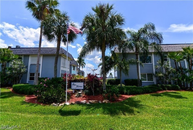 view of property exterior with a lawn and stucco siding