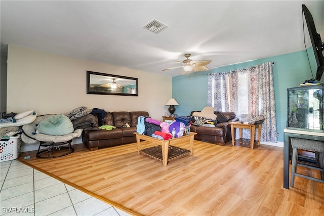 living room featuring light hardwood / wood-style flooring and ceiling fan