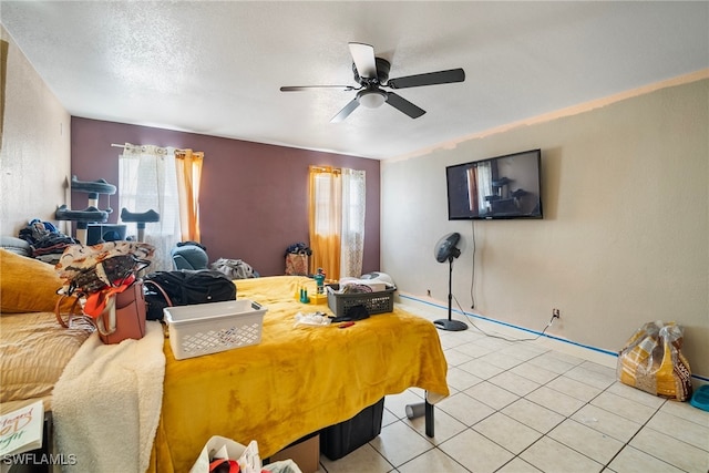 tiled bedroom featuring a textured ceiling and ceiling fan