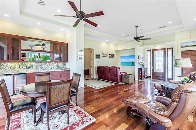 dining room with visible vents, a raised ceiling, a ceiling fan, and ornamental molding