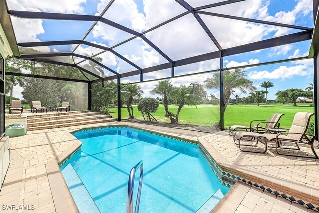 view of swimming pool with a lawn, a lanai, and a patio