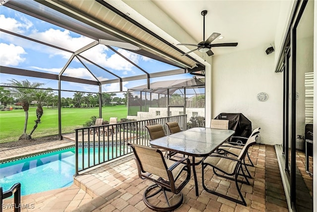 view of patio featuring glass enclosure, outdoor dining area, a ceiling fan, and an outdoor pool