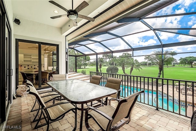 view of patio featuring a lanai, an outdoor pool, outdoor dining area, and a ceiling fan