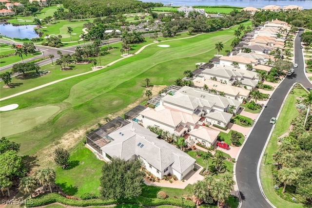 aerial view with a residential view, view of golf course, and a water view