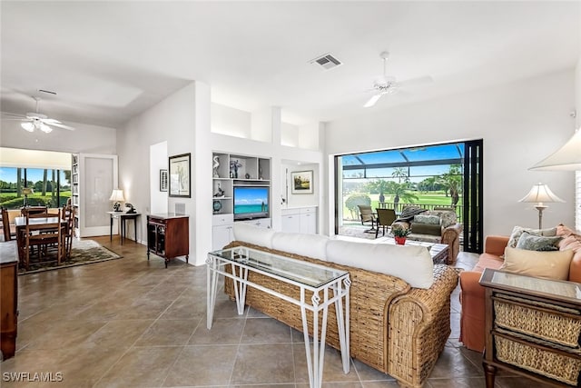 tiled living area with built in features, a ceiling fan, and visible vents