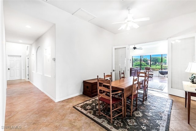 tiled dining room featuring baseboards and a ceiling fan