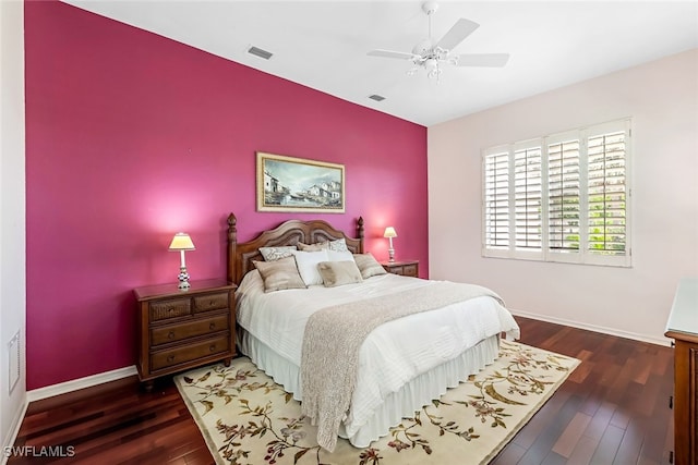 bedroom featuring visible vents, ceiling fan, baseboards, and wood finished floors