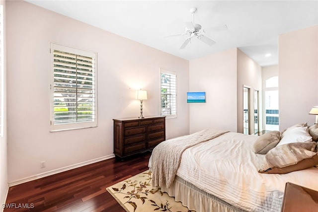 bedroom featuring baseboards, dark wood finished floors, and a ceiling fan