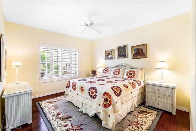 bedroom featuring dark wood finished floors, a ceiling fan, and baseboards