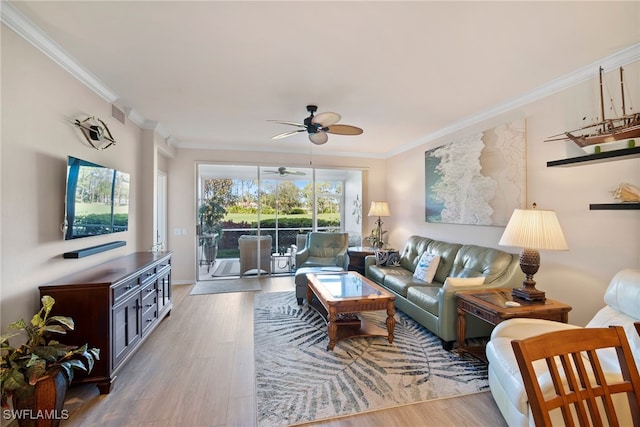 living room with ornamental molding, wood-type flooring, and ceiling fan