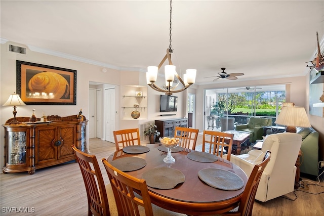 dining area with ceiling fan with notable chandelier, light hardwood / wood-style floors, and crown molding