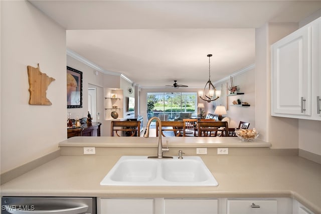 kitchen with ceiling fan with notable chandelier, dishwasher, ornamental molding, sink, and white cabinets