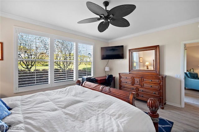 bedroom featuring crown molding, hardwood / wood-style floors, and ceiling fan