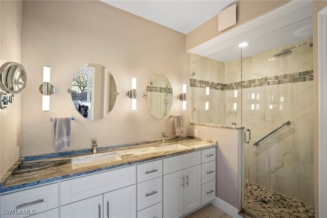 bathroom with walk in shower and vanity