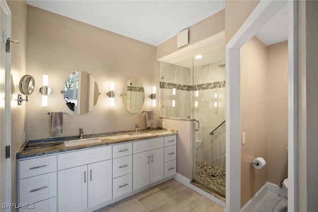 bathroom with a shower with door, vanity, and toilet