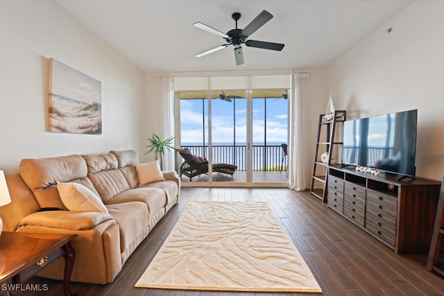 living room featuring ceiling fan and dark hardwood / wood-style flooring