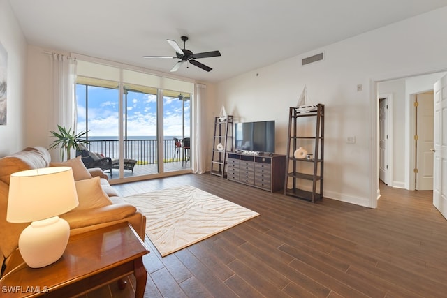 living room featuring dark hardwood / wood-style flooring and ceiling fan