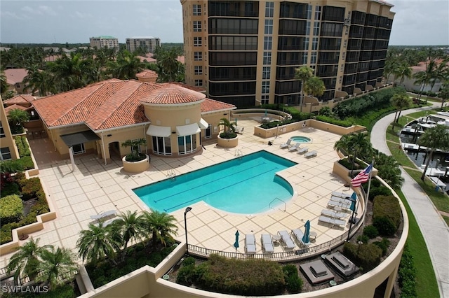 view of pool with a patio area and a hot tub