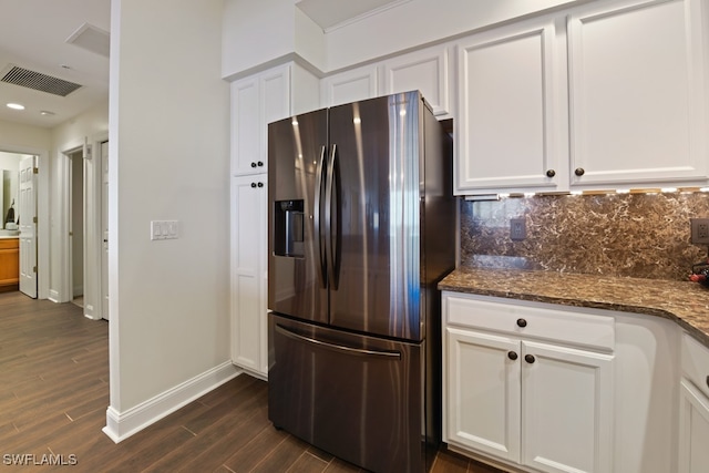 kitchen featuring stainless steel fridge, dark hardwood / wood-style floors, and white cabinetry