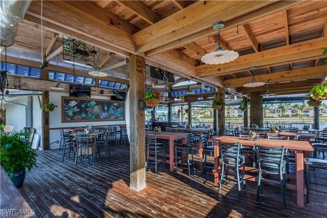 wooden terrace with ceiling fan and an outdoor bar