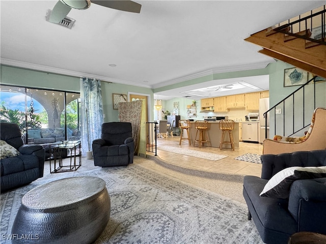 living room with crown molding and ceiling fan