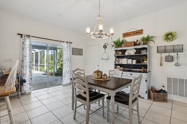 dining area featuring light tile patterned floors and a notable chandelier