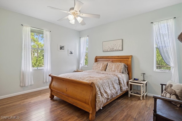 bedroom with ceiling fan and dark hardwood / wood-style flooring