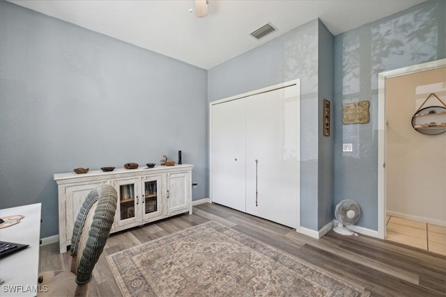 bedroom with a closet, ceiling fan, and hardwood / wood-style flooring