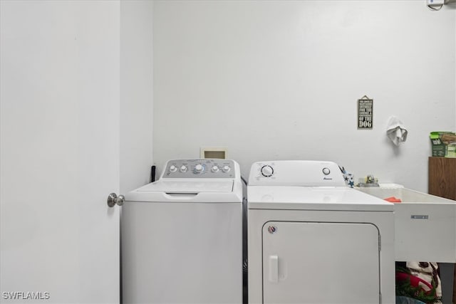 laundry area featuring washing machine and dryer and sink