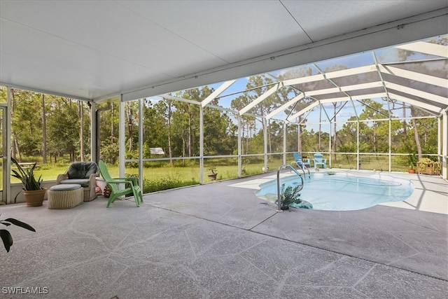 view of swimming pool featuring glass enclosure and a patio