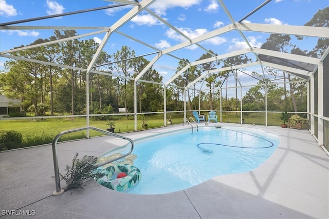 view of swimming pool featuring a yard, a lanai, and a patio area