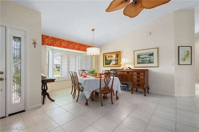 dining space featuring ceiling fan, vaulted ceiling, and light tile patterned floors